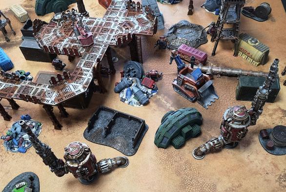 An overhead view of the scrapheap, utilising a variety of terrain sets including Necromunda and Star Wars