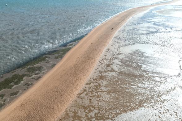 A sandbar, stretching out in the ocean