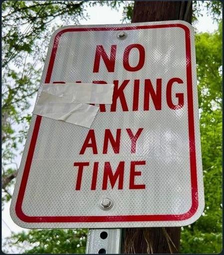 Road sign where normally it's written: No parking any time. 
But here the 'Par' of the word 'Parking' has been erased, thus the sentence becomes: No king any time