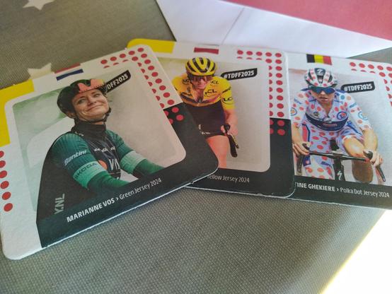 Professional bike racers Marianne Vos, Kasia Nieuwadoma & Justine Ghiekere,.each depicted on a beermat.