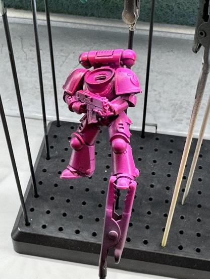 The space marine body for the figurine inspired color scheme. It was sprayed with a dark magenta ink and fluorescent pink ink.