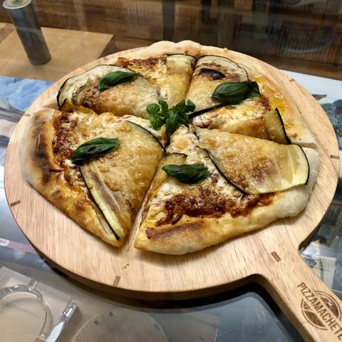 An eggplant & parmesan pizza, with a tomato base