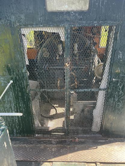 Picture of the inside of the Operator’s cab taken through a grille.