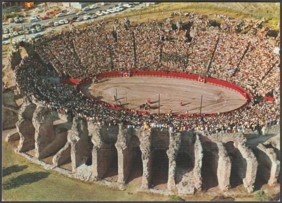 Printed colour linen-type postcard showing a view of bullfighting at the Arènes de Fréjus, a Roman amphitheatre in Fréjus in Var, France.

Published by Bandol, Les Editions Aris, No 20 248, c.1960s.

Postally unused.

Very good condition, with very slight corner bumps.