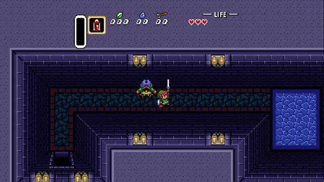 In the dimly lit dungeon, a hero in green is at the bottom of a flight of stairs. He stands ready with a sword in hand, poised to confront an enemy who waits at the top of the steps. A blue potion and a red heart are within reach on the ground. The environment is rocky, hinting at a challenging and possibly treacherous adventure.