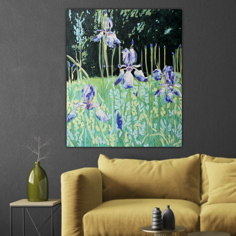A mock-up of how the abstracted painting of Siberian irises in a green garden would look hanging on a dark grey wall behind a overly stuffed mustard yellow sofa and a wooden side table with a wide olive-colour glass bottle.