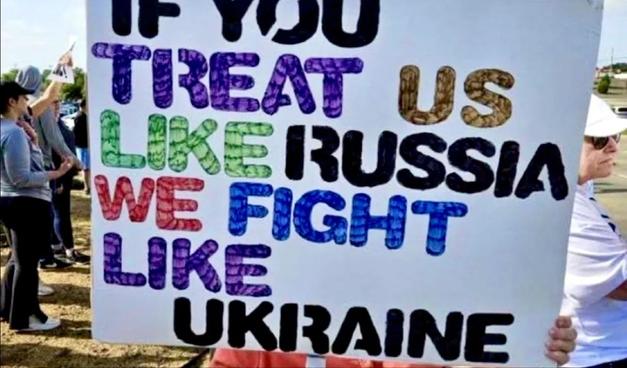 Sign that reads "If you treat us like Russia, we fight like Ukraine"