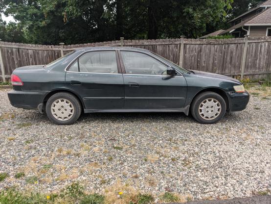 Side-on picture of a dark green Honda accord sedan