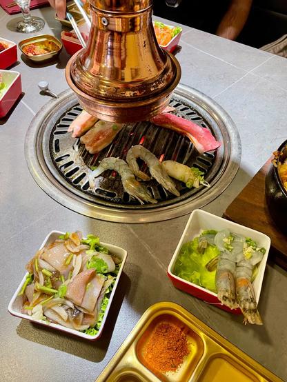 A table with a Korean bbq in the making