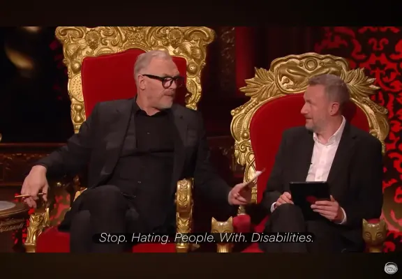 Greg Davies and "Little" Alex Horne in royal red and gold Baroque or maybe Rococo-style thrones, on the set of the show Taskmaster. God/s only know which gd series (season). Greg waves a prompt card nearer Alex. The captions read "'Stop. Hating. People. With. Disabilities."