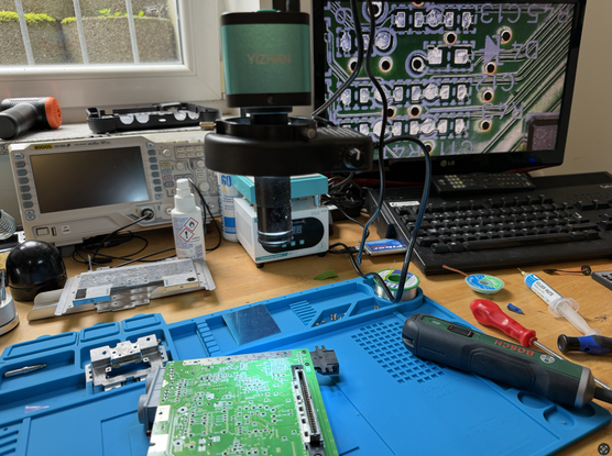Workbench with magnification setup, showing a N64-001 (FRA) motherboard empty RGB section before the mod