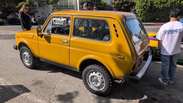 Rear 3/4 perspective of a butterscotch colored Lada 4x4 hatchback