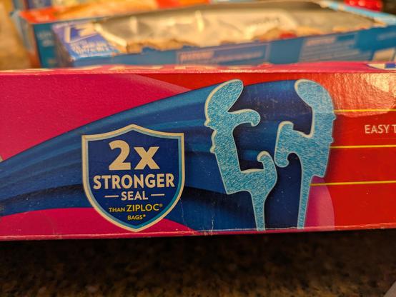 Picture of a box of Ziploc brand sealing bags, with a dramatic cross section of the sealing extrusion. It looks a lot like a bread bag clip in profile.