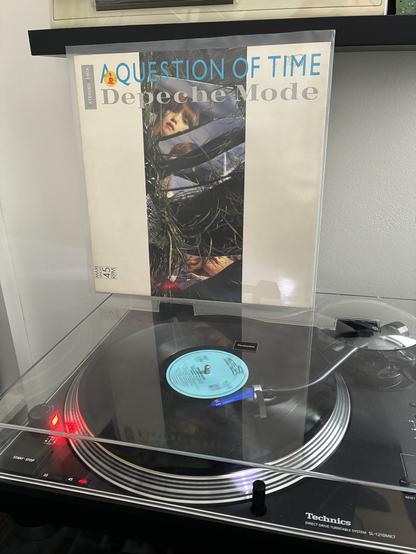Depeche Mode's 12" maxi single "A Question of Tim" playing on my record player. The B side is currently playing, third track, which is "Stripped".