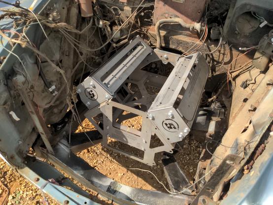 A photo of the engine bay of my Rover P5. The subframe (to which the engine and gearbox are bolted) is fitted to it, and fitted to the subframe is a mockup V8 engine made of steel plate.