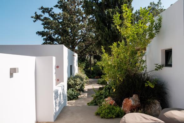Pathway through lush garden at Minos Beach Art Hotel, Crete.