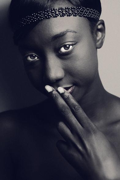 portrait of a young Senegalese model wearing a halter top and beaded headband