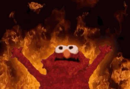 Elmo hell GIF, wo Elmo mit Armen hoch vor einer Flammenwand steht