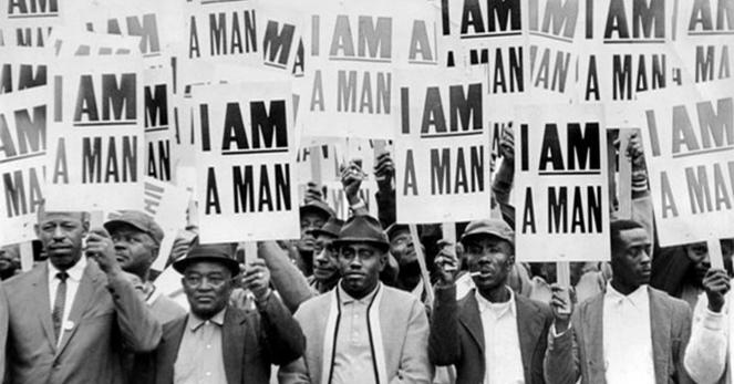 Black and white photo of a civil rights era protest. A group of Black protesters holding signs that all say “I am a man”