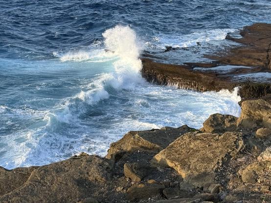 Wave crashing along a rocky shoreline