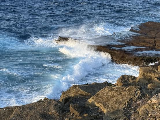 Wave crashing along a rocky shoreline