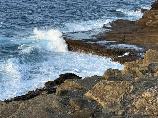 Wave about to crash on a rocky shoreline