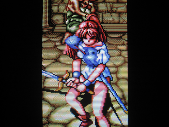A brave warrior brandishes her sword and defends a mother and child from the forces of Hades.