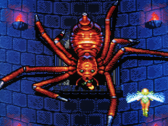 Sylphia is menaced by a gigantic red spider boss crawling up the inside of a dark tower.