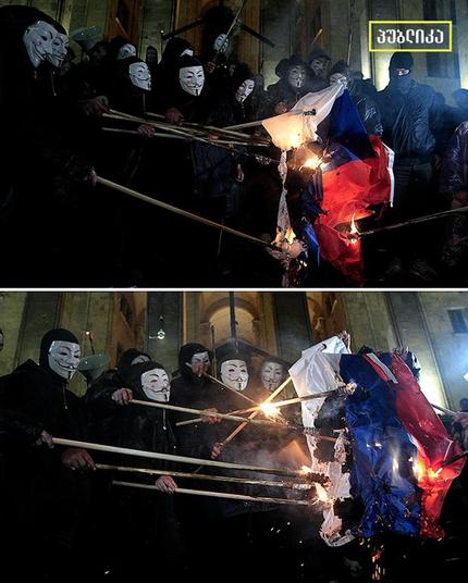 Anonymous protestors burn the Russian flag
