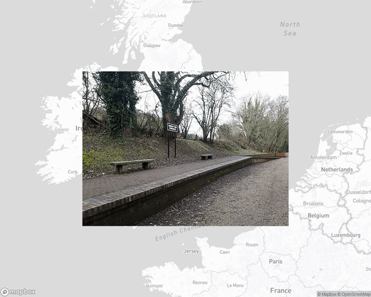 A photo of or from a train station from the linked website, overlaid on a cropped world map where it's located.