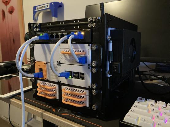 my server cluster made from 3d printed parts, a custom PSU, and old mini itx case and a bunch of small server SBC's and a RAID array of 6 disks