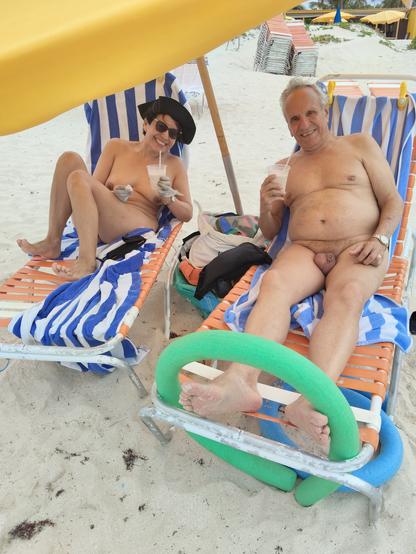 Rosi and Gerardo, nude, enjoying their happy hour mudslides on Orient Beach, Saint Martin, French West Indies.