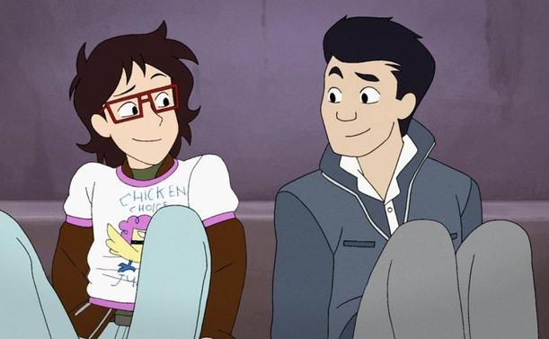 Screenshot from episode 6, The Party Car. Ryan and Min-Gi are sitting inside the bathtub, warmly smiling at each other. Ryan has the Chicken Choice Judy t-shirt on over his jacket and sweater.