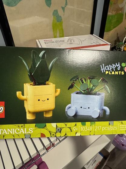 A lego set depicting two small plant pots with cute little faces, arms and legs