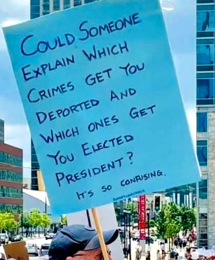 sign says: could someone explain which crimes get you deported and which ones get you elected president. it's so confusing.