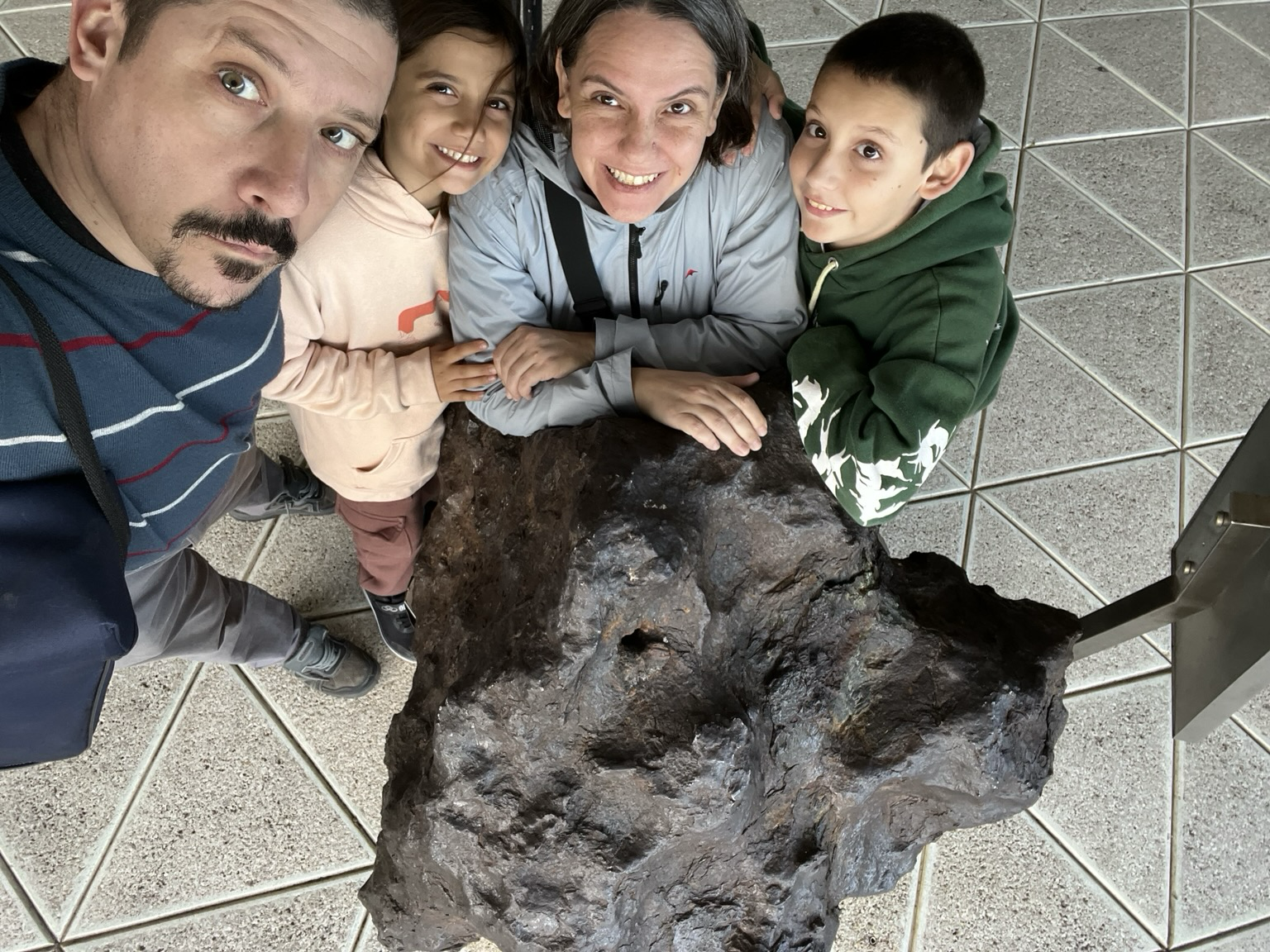 Yani and her family touching the meteorite.