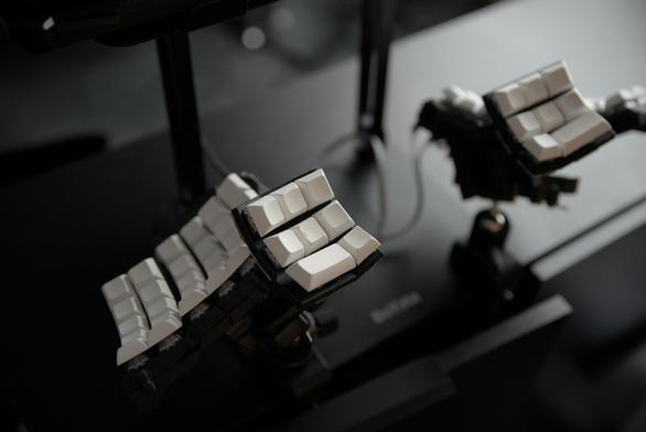 A view of my Dactyl Lynx ergonomic keyboard attached to a cabinet using C-clamps and ball mounts.