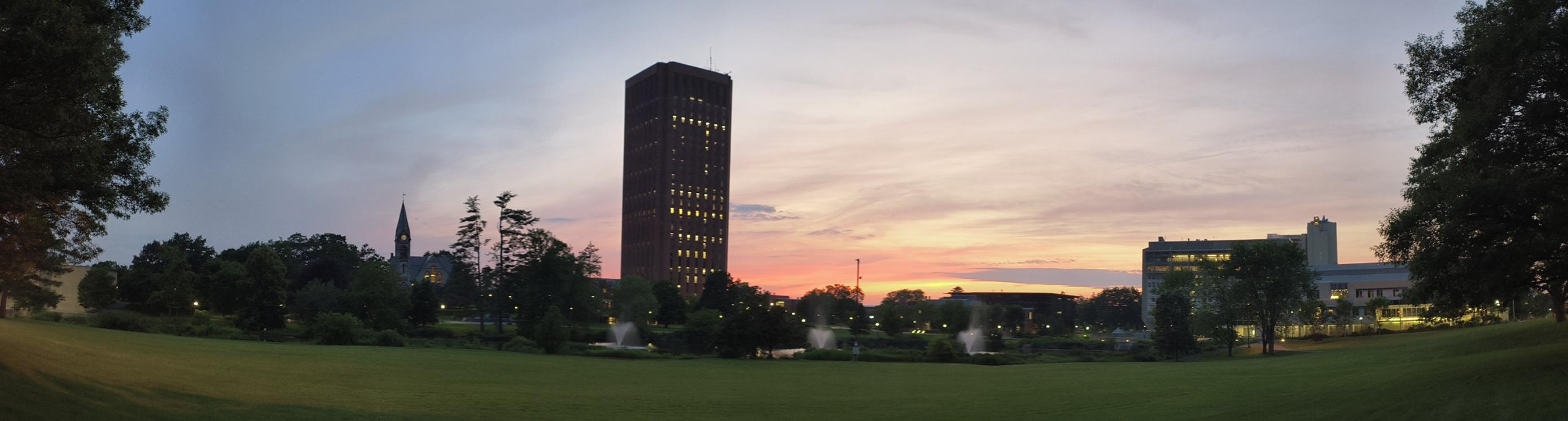 panorama of umass skyline with the old chapel dubois library and other landmarks framing a sunset