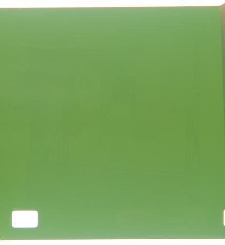 Digital photograph of a film negative exposed in 1983 and not developed until 2025. It's mostly a weird shade of green but a few very faint streaks indicate there may be an image.