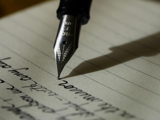 An old style of pen writing on lined paper with black ink in an English script.