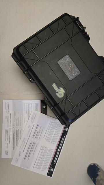 the box for my Positron 3d printer on a table with two slips from Canadian Air Transport Security Authority saying they searched the duffel bag it was in. One looks like they thought about keeping it, then thought again and scribbled that out. Not pictured, the dirty laundry.