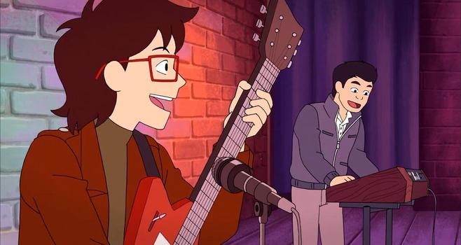 Screenshot from episode 10, The Train to Nowhere. Side profile from the left of Ryan and Min-Gi performing at the open mic show in Utica.