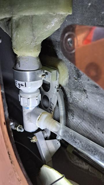 The bottom of the tank has a dump valve.

In order to do this installation, I had to remove most of the hardware for the elevator control linkage.