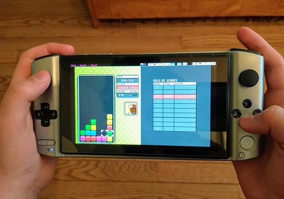 Hand held game console playing a puzzle game in quadplay