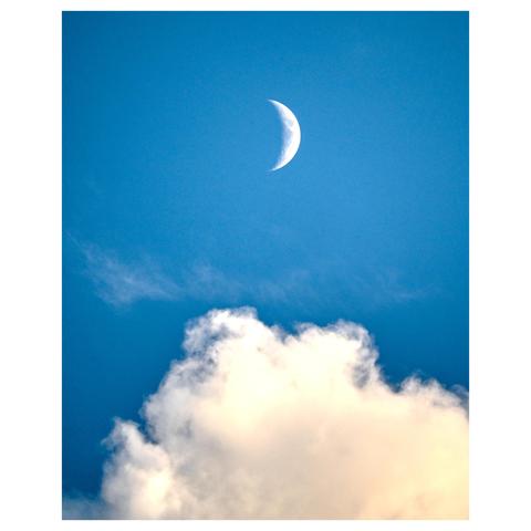 A serene blue sky with a crescent moon positioned in the upper portion of the frame. Below the moon, there are fluffy, white clouds scattered across the sky, illuminated by a soft light. The sky transitions from a deep blue at the top to a lighter, warmer hue near the horizon. (made with help of Mistral.ai)