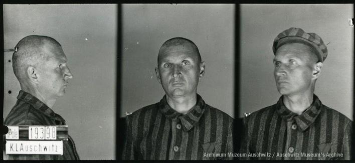A mugshot registration photograph from Auschwitz. A man with a shaved head wearing a striped uniform photographed in three positions (profile and front with bare head and a photo with a slightly turned head with a hat on). The prisoner number is visible on a marking board on the left.