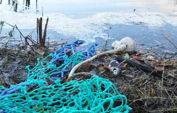 Ceramic buoy and ceramic fishing net on a riverside like a waste.
Mix-media sculpture project.