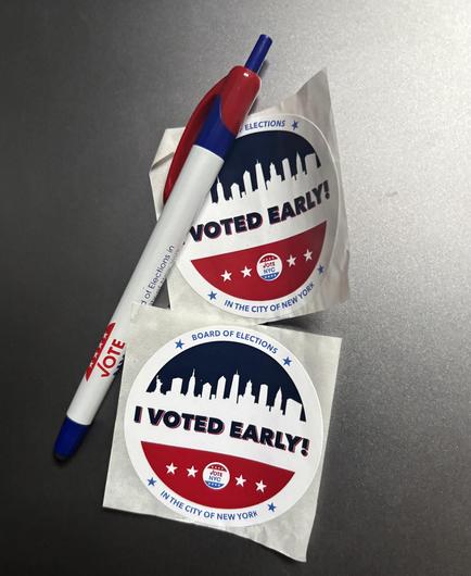 Two “I voted early!” stickers and a voting pen/ stylus.