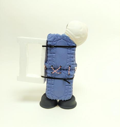 Ceramic slip casted plastic container pitcher. Looks like its being hold with strings and zipties. Handle is styrofoam. Spout is ceramic made from the top of a plastic water bottle. Base is ceramic slip cast from yogurt containers. Body is ceramic slip cast from vegetable plastic containers.
Displayed on white background.