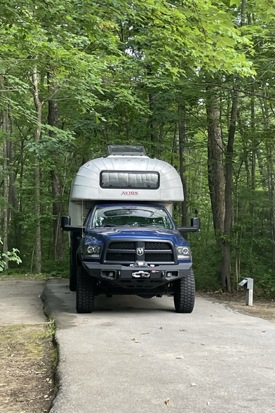 Truck camper parked in a forest